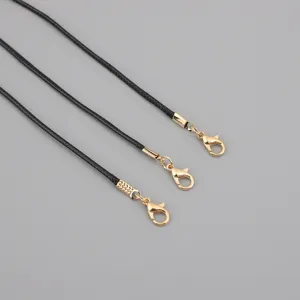 Close-up detail of black waxed cord necklace cords with durable gold lobster clasps
