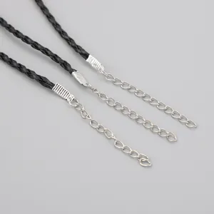 Close-up of black braided necklace cords featuring silver metal extension chains and end caps.
