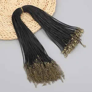 Detail of black waxed cord necklace strings with antique bronze lobster clasps for DIY.