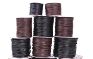 Stacked rolls of black and brown Korean waxed cord for DIY jewelry making crafts