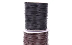 Detailed macro view of black and brown Korean wax cords on white plastic spools