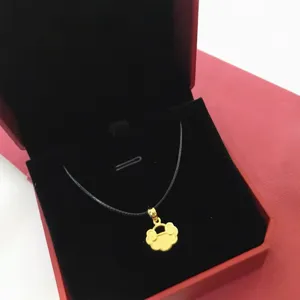 Traditional golden Ruyi lock pendant on a black Korean wax cord in a red velvet gift box