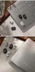 Detailed macro view of zodiac constellation nail stamping plate with black white tips.