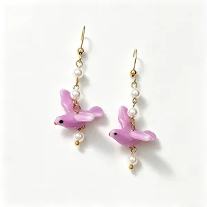 Close-up view of purple ceramic bird drop earrings with pearls and gold-plated hooks.
