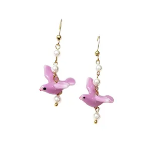 Elegant purple ceramic pigeon dangle earrings with white pearls on gold-toned hooks