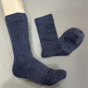 Close-up detail of dark blue merino wool mid-calf socks showcasing ribbed cuff and soft texture.