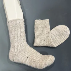 Detailed view of women cozy mid-tube woolen socks with cute colorful speckles and warm fuzzy texture.