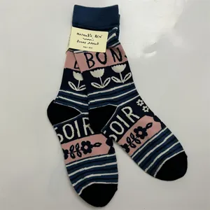 Detail view of designer cotton mid-calf socks with floral pattern and letter knit print.
