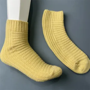 Detail view of women's yellow ribbed wool blend mid-calf socks showing fine texture and knit.