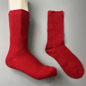 Red merino wool socks detail, ribbed knit texture, comfortable winter thermal hosiery.