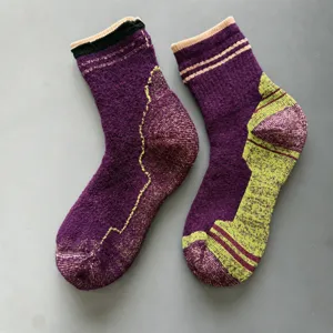 Close-up of thickened merino wool hiking socks with loop cushion sole and ribbed cuff detail.