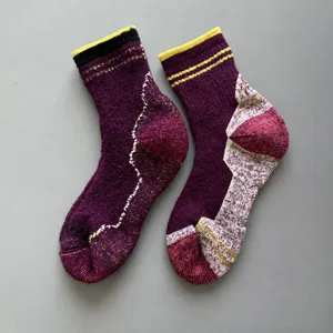 Detailed view of thick merino wool thermal socks with cushioned sole, ideal for outdoor sports.