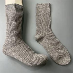 Close-up view of grey merino wool ribbed mid-tube socks, showing fine knit texture and details.