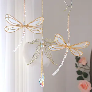 Elegant metal dragonfly suncatcher ornaments with iridescent crystal prisms for home decor.