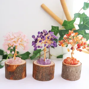 Detail view of handmade crystal tree of life ornaments with natural wood bases.