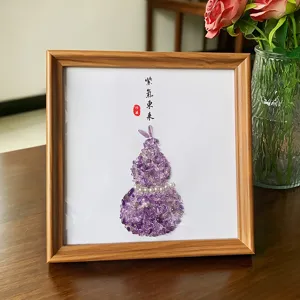 Handcrafted amethyst crystal gravel gourd art in a wooden frame for home decor