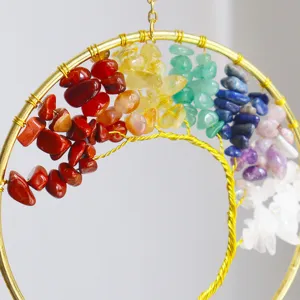 Macro detail of hand-wired Tree of Life suncatcher with rainbow natural crystals.
