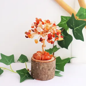 Handcrafted natural orange crystal tree of life ornament with a rustic wooden stump base