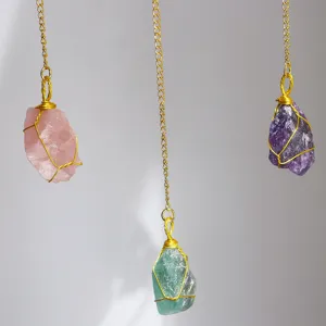Close-up of hand-wired raw crystal suncatchers in amethyst, quartz, and fluorite
