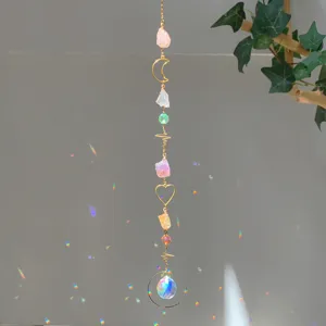 Close-up of a natural crystal suncatcher hanging ornament with rainbow light effects