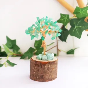 Close-up detail of the green crystal leaves and rustic wood base of the money tree