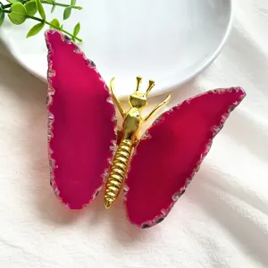 Close-up of a pink natural agate slice butterfly ornament for home table decor