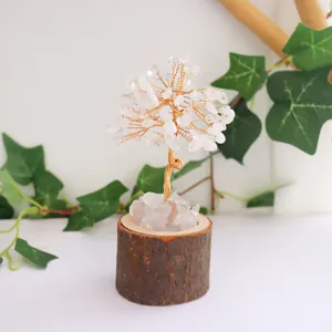 Close-up of handmade natural crystal tree of life with rustic wooden stump base