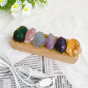 Natural raw crystal night light with wooden base and USB cable detail