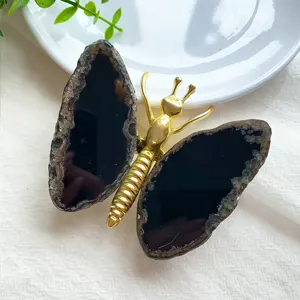 Detailed view of handmade butterfly ornament featuring natural agate wings and gold metal body