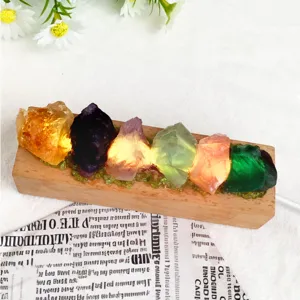 Close-up of natural raw crystal night light with wooden base glowing softly
