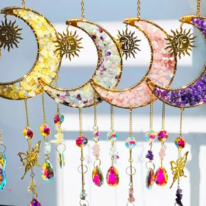 Close-up of crystal moon suncatchers with butterfly pendants in vibrant colors.