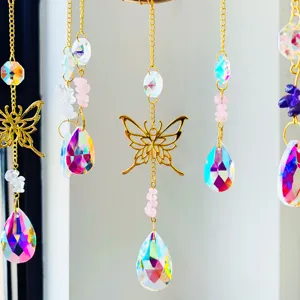 Close-up of crystal suncatcher with golden butterfly and iridescent teardrop pendant