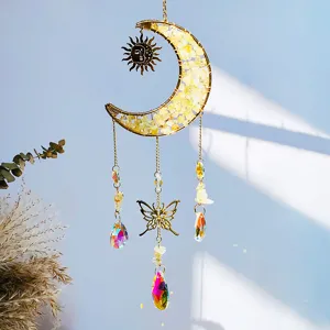 Detailed view of moon suncatcher with yellow crystals, butterfly charm and rainbow drops.
