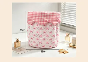 Quilted pink bow storage basket with 23cm dimensions for desk organization.