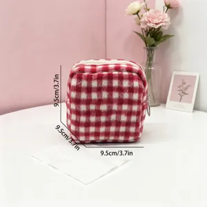 Detail view of compact red and white gingham plaid wool storage pouch with measurements