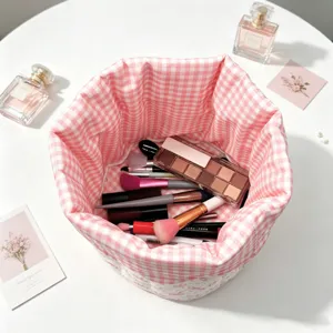 Detail of pink gingham quilted storage basket filled with various makeup items