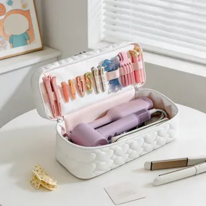 Detailed interior view of a white quilted travel bag for hair dryer and tools