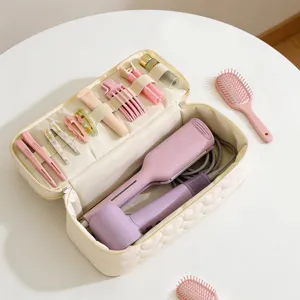 Detail of large capacity quilted travel organizer bag for hair dryer and accessories