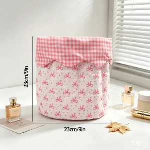 Close-up view of a pink quilted bow storage basket showing dimensions and fabric texture