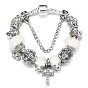 Punk style silver charm bracelet with white luminous skulls and rhinestone cross charms