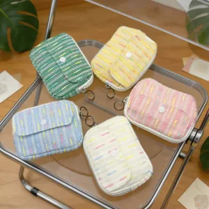 Soft tweed flap coin purses in multiple colors with snap buttons and ring keychains.
