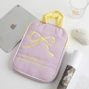 Vista detallada de la funda acolchada violeta para tableta con lazo amarillo y asa