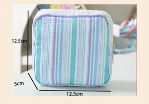 Detail view of striped seersucker pouch showing 12.5cm x 12.5cm x 5cm dimensions