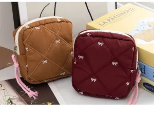Quilted bow storage bags in brown and burgundy for cosmetics or sanitary napkins
