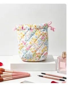 Quilted floral cosmetic bag with pink drawstring closure for travel makeup organization