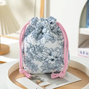 Macro view of a quilted floral drawstring pouch showing the high quality soft fabric texture