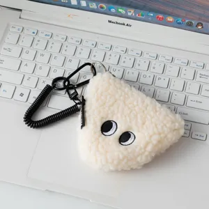 Close-up of cute rice ball plush coin purse with embroidered eyes and black keychain