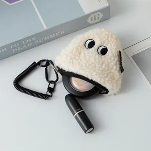 Detail view of plush rice ball coin purse showing zipper and lipstick storage.