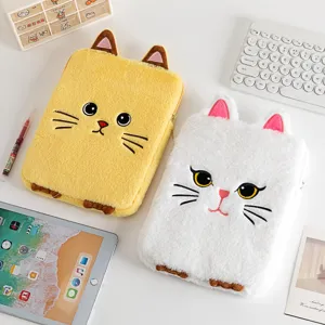 Detailed view of two cute plush cat iPad sleeves on a desk with a keyboard and tablet
