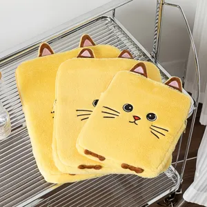 Three cute yellow plush cat-themed iPad and laptop sleeves in various sizes on a rack